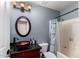 Bathroom with a vanity, oval mirror, decorative sink, and bathtub with shower features at 11346 E Renata Ave, Mesa, AZ 85212