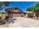 Well maintained home with a spacious driveway and mature trees in the front yard at 11346 E Renata Ave, Mesa, AZ 85212