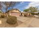 Charming home with a spacious driveway, desert landscaping and a view of neighboring houses at 11346 E Renata Ave, Mesa, AZ 85212