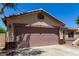 A two-car garage with a tile roof and a stucco exterior, complementing the home's architecture at 11346 E Renata Ave, Mesa, AZ 85212
