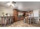 Well-lit kitchen with stainless steel appliances, wooden cabinets and island with breakfast bar at 11346 E Renata Ave, Mesa, AZ 85212