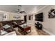 Comfortable living room includes a big brown couch and a wall mounted television at 11346 E Renata Ave, Mesa, AZ 85212