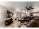 Relaxing living room with decorative ceiling fan and comfortable brown couches at 11346 E Renata Ave, Mesa, AZ 85212
