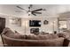 Cozy living room with a ceiling fan and a comfortable brown sofa at 11346 E Renata Ave, Mesa, AZ 85212