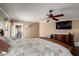 This main bedroom has a ceiling fan and dark stained wood floors at 11346 E Renata Ave, Mesa, AZ 85212