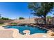 Sparkling pool featuring a waterfall and in-pool table and a beach entry, perfect for backyard enjoyment at 11346 E Renata Ave, Mesa, AZ 85212
