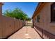 Property's side yard has gravel, pavers, a gate, and stucco walls for privacy at 11346 E Renata Ave, Mesa, AZ 85212