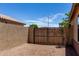 This side yard has a privacy wall and a wood gate to the backyard at 11346 E Renata Ave, Mesa, AZ 85212