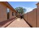 Side yard featuring desert landscaping, walkway and partial view of the house at 11346 E Renata Ave, Mesa, AZ 85212