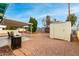 Backyard with covered patio, storage shed and grill at 1417 S Grand Dr, Apache Junction, AZ 85120