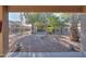 Landscaped backyard with gravel, trees, and a covered patio at 143 S Los Cielos Ln, Casa Grande, AZ 85194