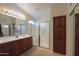 Bathroom with double vanity, shower, and linen storage at 143 S Los Cielos Ln, Casa Grande, AZ 85194