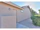Side yard with stucco wall and access to a storage area at 143 S Los Cielos Ln, Casa Grande, AZ 85194