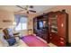 Relaxing media room with comfy seating and large media cabinet at 143 S Los Cielos Ln, Casa Grande, AZ 85194