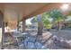 Outdoor patio with metal table and chairs, overlooking the backyard at 143 S Los Cielos Ln, Casa Grande, AZ 85194