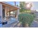Covered patio with table and chairs, surrounded by desert landscaping at 143 S Los Cielos Ln, Casa Grande, AZ 85194