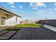 Artificial turf backyard with paved patio and sitting wall at 1447 S 239Th Dr, Buckeye, AZ 85326