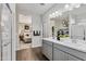 Modern bathroom with double vanity, walk-in shower, and bedroom view at 1447 S 239Th Dr, Buckeye, AZ 85326