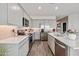 Modern kitchen with island, stainless steel appliances, and ample cabinet space at 1447 S 239Th Dr, Buckeye, AZ 85326