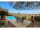 Relaxing poolside patio with table and chairs, fire pit and mountain views at 15234 E Sundown Dr, Fountain Hills, AZ 85268