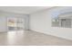 Bright and spacious living room with tile flooring and large window at 1559 S 239Th Dr, Buckeye, AZ 85326