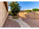 Landscaped backyard with a winding pathway and fruit trees at 16027 N 158Th Ct, Surprise, AZ 85374