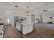 Modern kitchen with large island, stainless steel appliances, and white cabinets at 16637 W La Reata Ave, Goodyear, AZ 85395