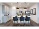 Modern kitchen with gray cabinets, white quartz island, and wood floors at 17176 W Corrine Dr, Surprise, AZ 85388