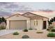 One-story home with tile roof and two-car garage at 18214 W Daley Ln, Surprise, AZ 85387