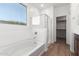 Bathroom with soaking tub and walk-in shower at 18398 W Monte Lindo Ln, Surprise, AZ 85387
