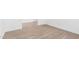 Bright bedroom with neutral carpeting and wood-look tile flooring at 18398 W Monte Lindo Ln, Surprise, AZ 85387