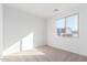 Bright bedroom with carpet flooring and large window at 18398 W Monte Lindo Ln, Surprise, AZ 85387