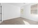 Spacious bedroom with two windows and carpet at 18398 W Monte Lindo Ln, Surprise, AZ 85387