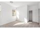 Well-lit bedroom with window and closet at 18398 W Monte Lindo Ln, Surprise, AZ 85387