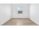 Bright and airy bedroom with wood-look flooring at 18398 W Monte Lindo Ln, Surprise, AZ 85387