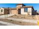 Newly built home with a two-car garage and small front yard at 18398 W Monte Lindo Ln, Surprise, AZ 85387