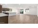 Modern kitchen with island, stainless steel appliances, and wood cabinets at 18398 W Monte Lindo Ln, Surprise, AZ 85387