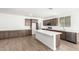 Spacious kitchen with island, white countertops, and dark cabinets at 18398 W Monte Lindo Ln, Surprise, AZ 85387