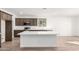 Modern kitchen with a large island and stainless steel appliances at 18398 W Monte Lindo Ln, Surprise, AZ 85387