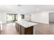 Open concept kitchen with an island and access to the backyard at 18398 W Monte Lindo Ln, Surprise, AZ 85387