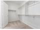 Spacious walk-in closet with double hanging rods at 18398 W Monte Lindo Ln, Surprise, AZ 85387