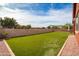 Artificial turf backyard with a block wall and partial home view at 19087 E Walnut Ct, Queen Creek, AZ 85142