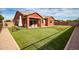 Backyard with artificial turf, covered patio, and seating area at 19087 E Walnut Ct, Queen Creek, AZ 85142