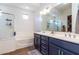 Bathroom with double vanity, soaking tub, and walk-in shower at 19087 E Walnut Ct, Queen Creek, AZ 85142
