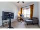 Bright home office features built-in desk, comfortable seating, and large window at 19087 E Walnut Ct, Queen Creek, AZ 85142