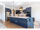 Modern kitchen with blue cabinets, island, and stainless steel appliances at 19087 E Walnut Ct, Queen Creek, AZ 85142