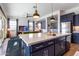 Spacious kitchen island with seating and a built-in sink at 19087 E Walnut Ct, Queen Creek, AZ 85142