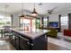 Modern kitchen island with white countertop and dark cabinets at 19087 E Walnut Ct, Queen Creek, AZ 85142