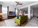 Spacious living room with green couch and large TV at 19087 E Walnut Ct, Queen Creek, AZ 85142