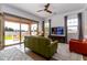 Living room with green couch and sliding glass doors to backyard at 19087 E Walnut Ct, Queen Creek, AZ 85142